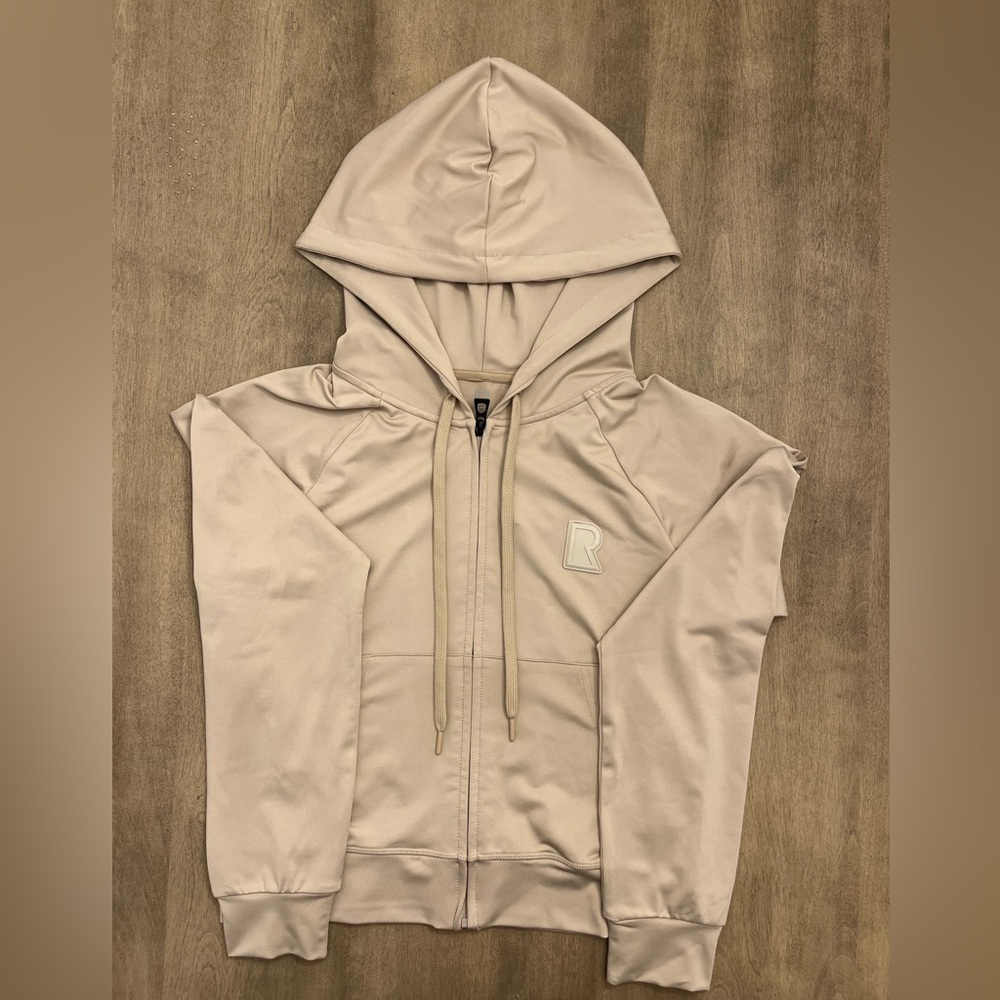 Woman’s stylish tan Rudsak hoodie, size medium, brand new with tags.